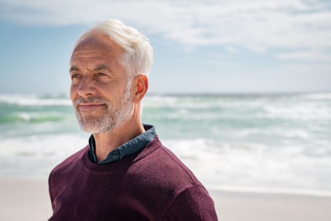 Portrait,of,pensive,senior,man,at,beach,looking,away.,proud