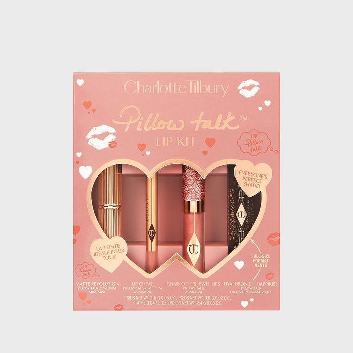 Lipsticks displayed in a heart-shaped box. Text reads â€œCharlotte Tilbury Pillow Talk Lip Kit.â€ Pink packaging with hearts and decorative designs.