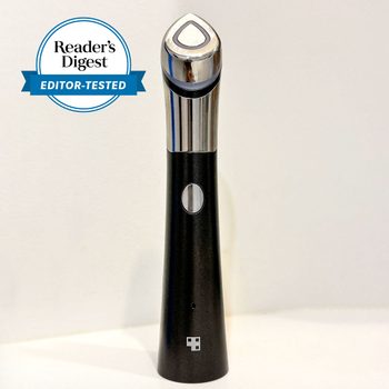 Device stands upright, displaying a sleek design and metallic top, set against a plain background. "Reader's Digest Editor-Tested" badge is visible.