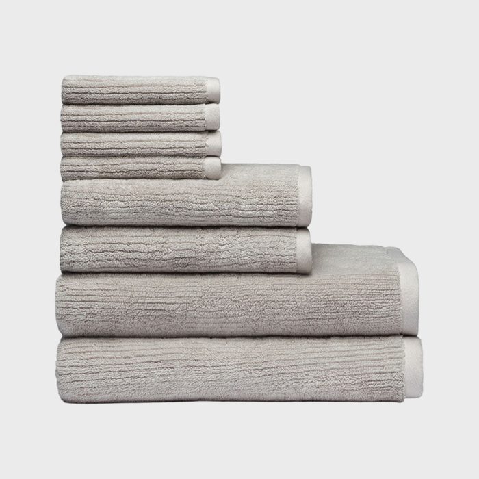 Towels are stacked neatly; six pieces in ascending order; set against a plain white background.