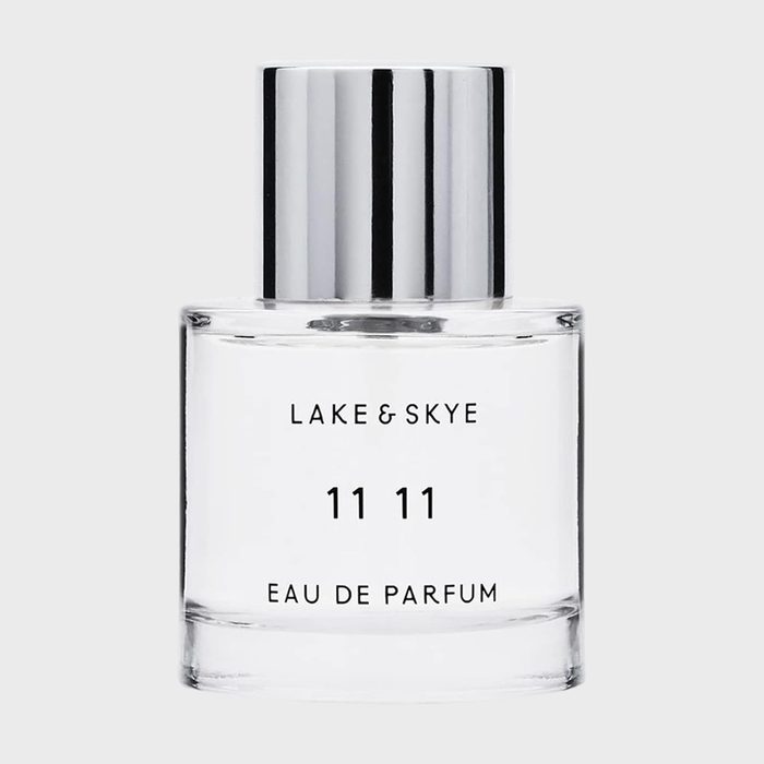 Perfume bottle sits on a plain background; labeled 