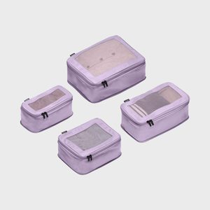 Four lavender packing cubes are neatly arranged, each with a mesh top and zippers, displayed on a plain white background.