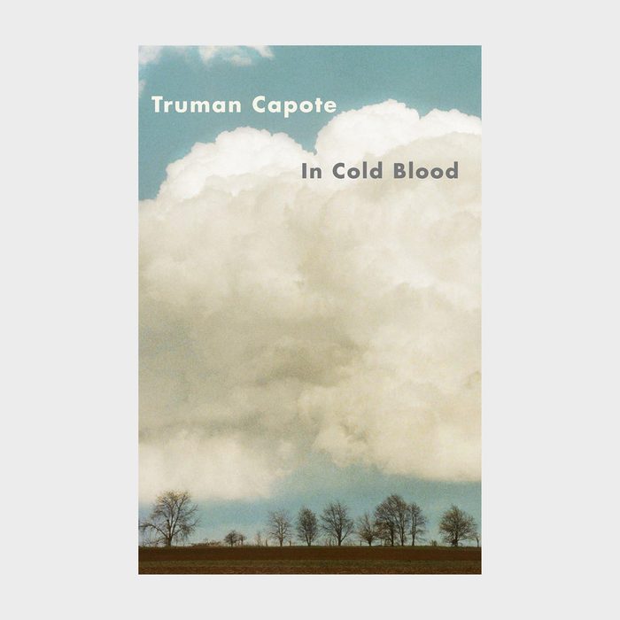 Clouds hover above a row of leafless trees on a flat landscape; text reads: 