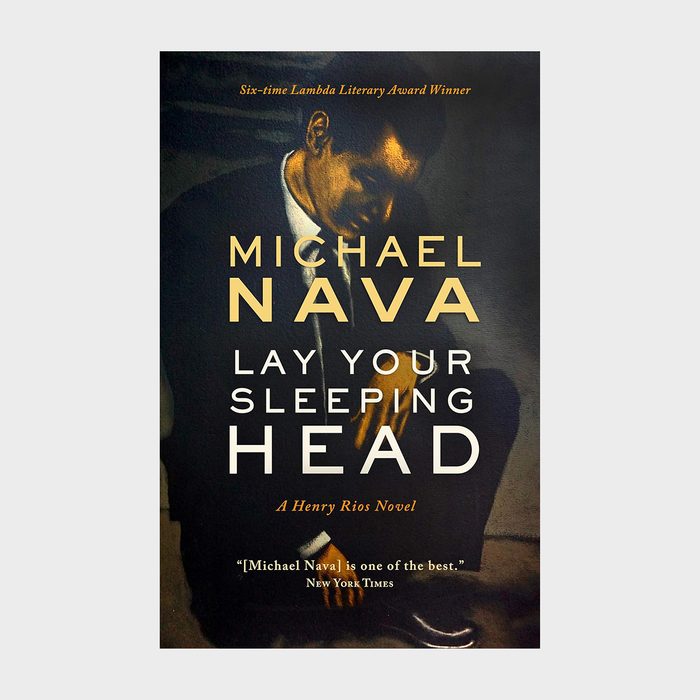 A person sits in darkness; the book cover features the title 