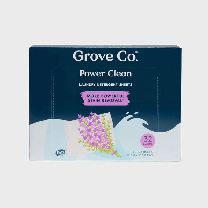 Box displays lavender blooms, promoting laundry detergent sheets with powerful stain removal for 32 loads. Background features wave-like design elements.