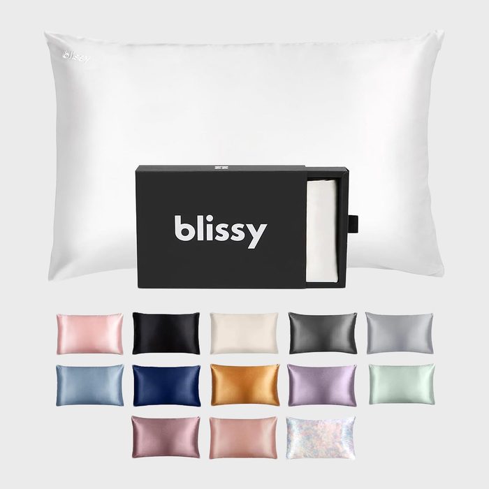 Pillow rests behind a partially opened black box labeled 