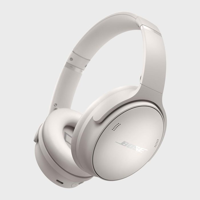 White over-ear headphones angled, floating against a plain background; 