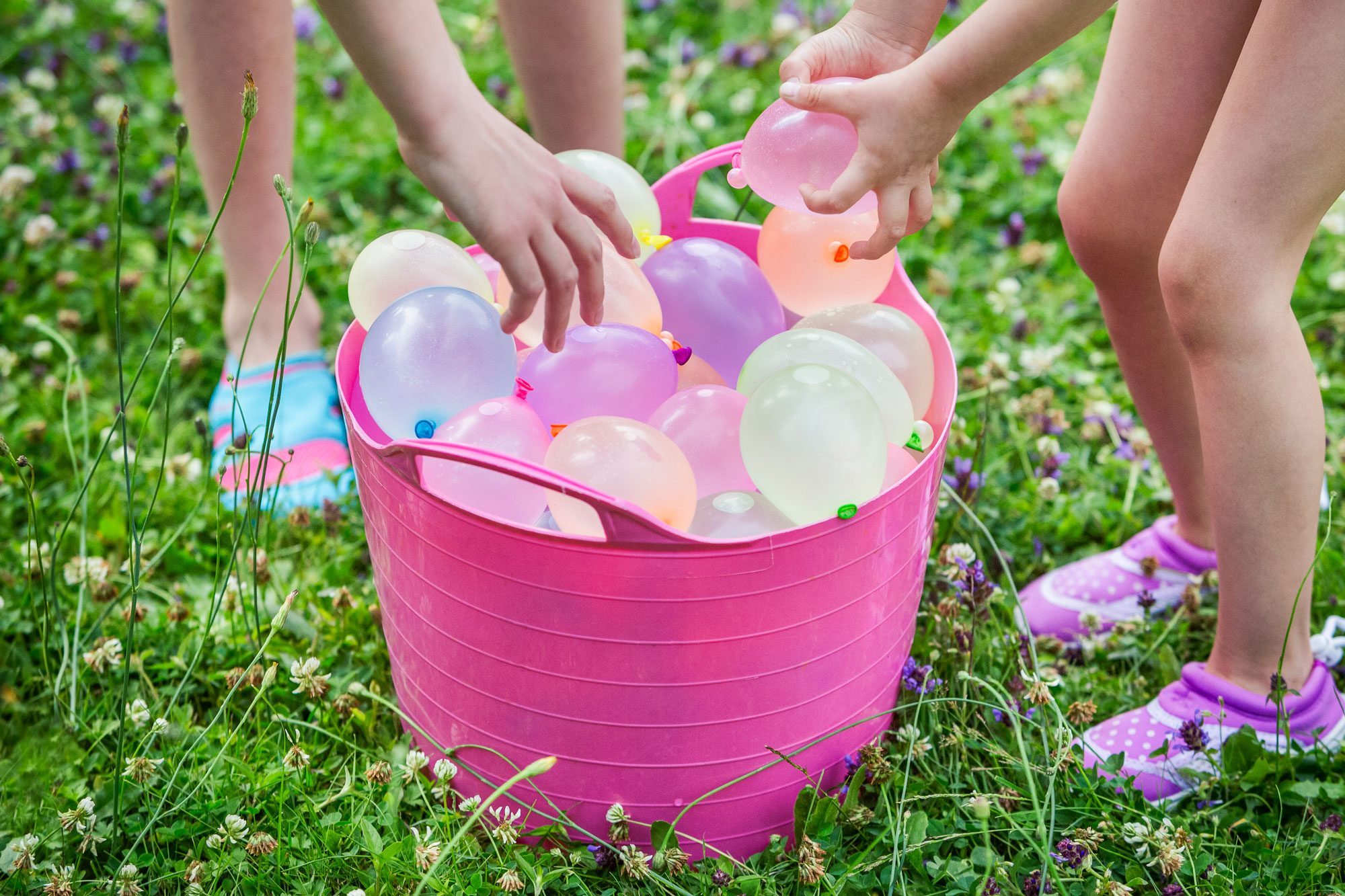 Children Grabbing Water Balloons From A Bucket