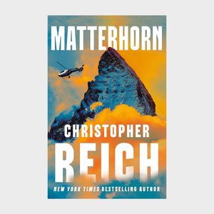 A helicopter flies near a jagged mountain peak against a vibrant orange and blue sky. Text reads: 