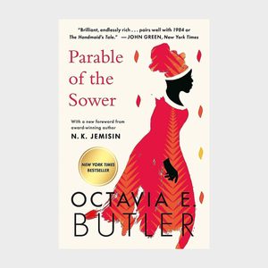 Silhouette of a woman in a vibrant dress stands against a cream background, adorned with red and yellow leaf motifs; book title displayed.