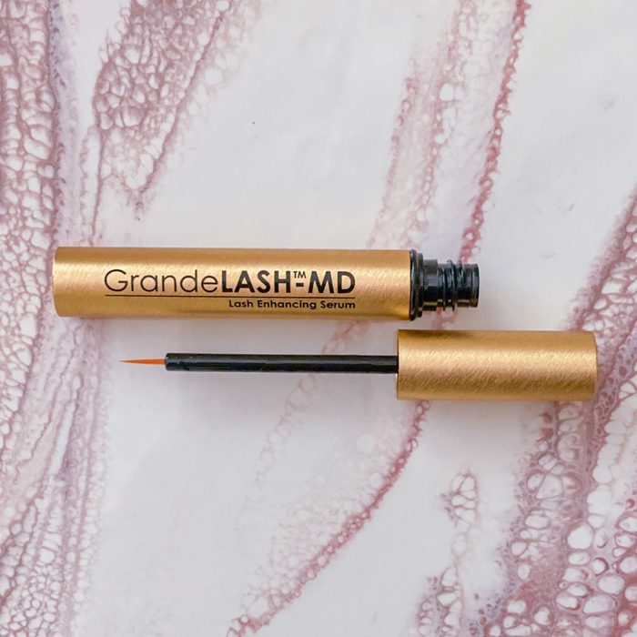 Gold tube with black brush, labeled 
