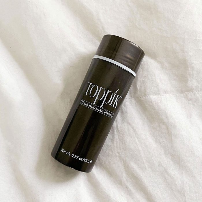 A cylindrical container lies on a white surface, labeled 