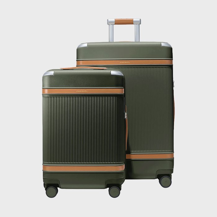 Two olive green suitcases stand together; one has an extended handle. Both feature brown accents and are positioned against a plain, light background.