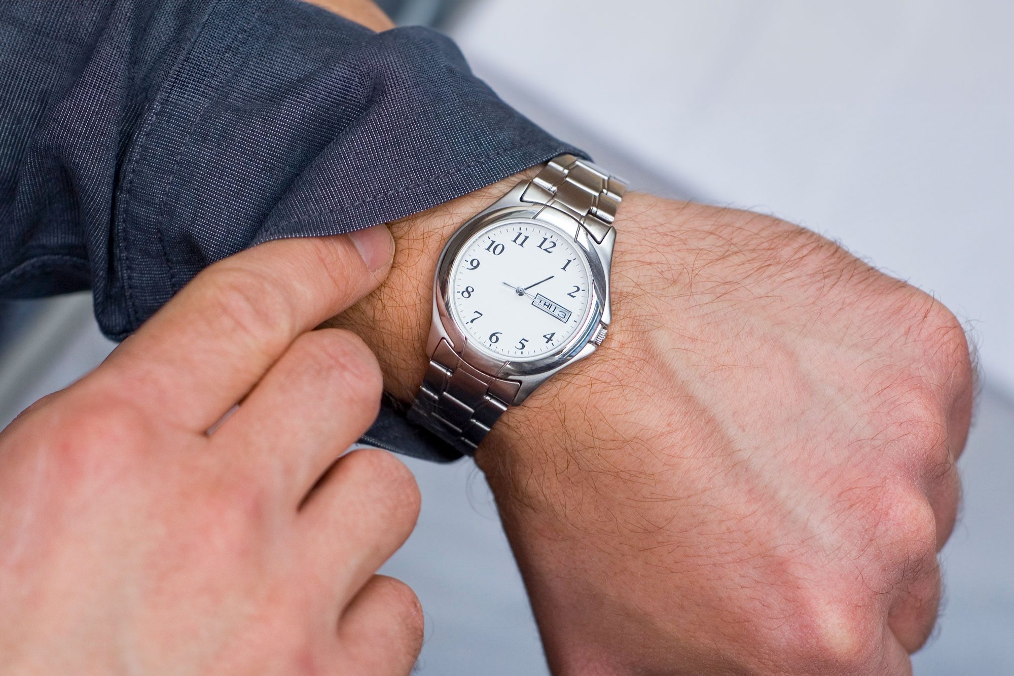 Man Checking The Time On His Watch