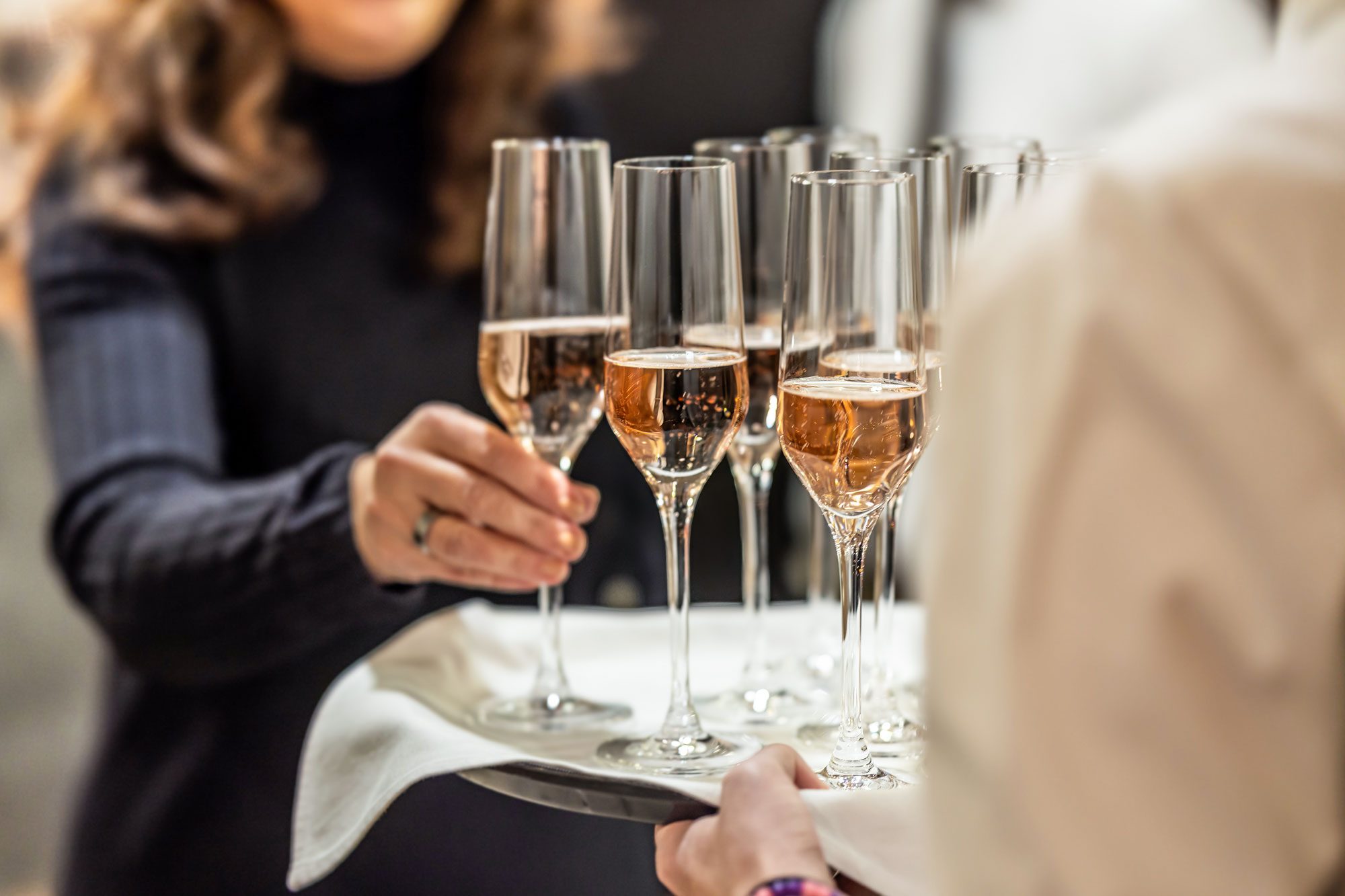 Women Picking Up Glass Of Wine