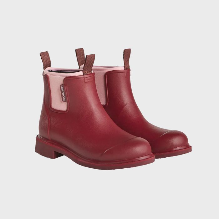 Red rubber ankle boots resting against a plain white background, featuring pull tabs and elastic side panels with a visible brand tag.