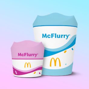 Two McFlurry cups, one pink and one blue, stand side-by-side. The background shows a gradient from pink to blue.