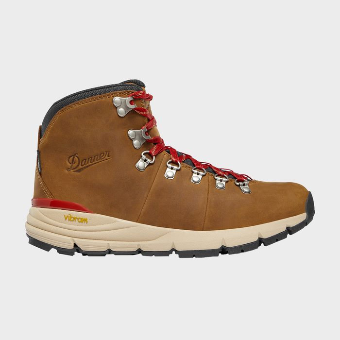 Brown leather hiking boot with red laces sits against a plain background; features include metal eyelets and 