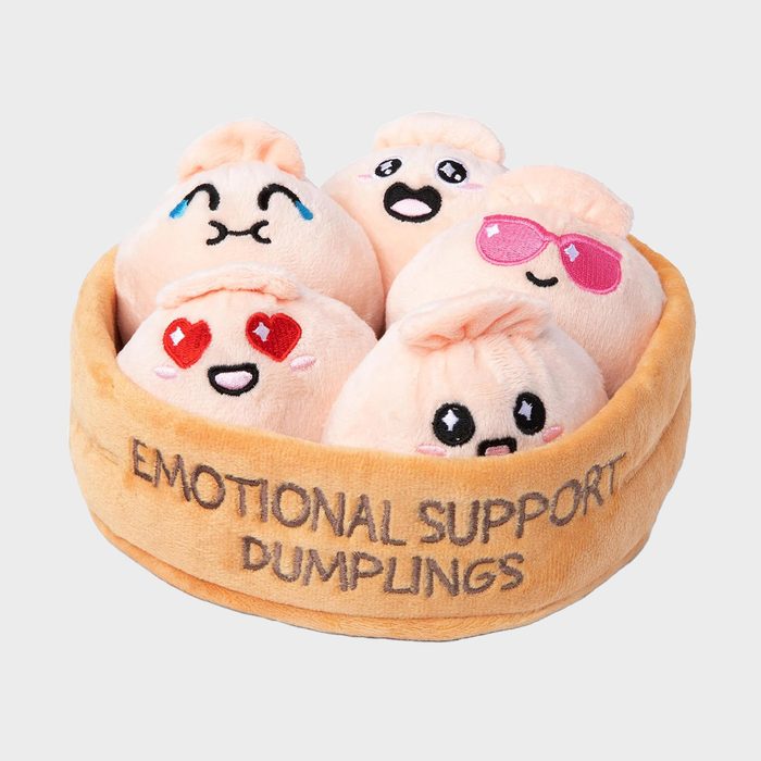 Plush dumplings display various facial expressions in a round basket labeled 