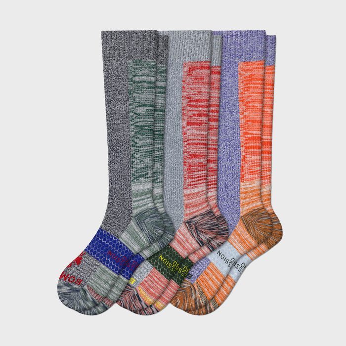 Socks are displayed upright, showcasing various colorful patterns and designs, overlapping slightly on a plain white background.