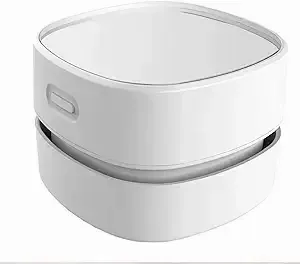 A white, round-edged container with a lid sits stationary, featuring a small handle on its side; likely in a neutral, indoor setting.
