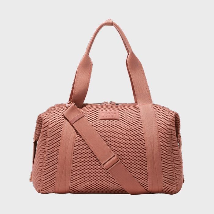 A pink duffel bag with handles and shoulder strap rests against a plain gray background. Text reads 