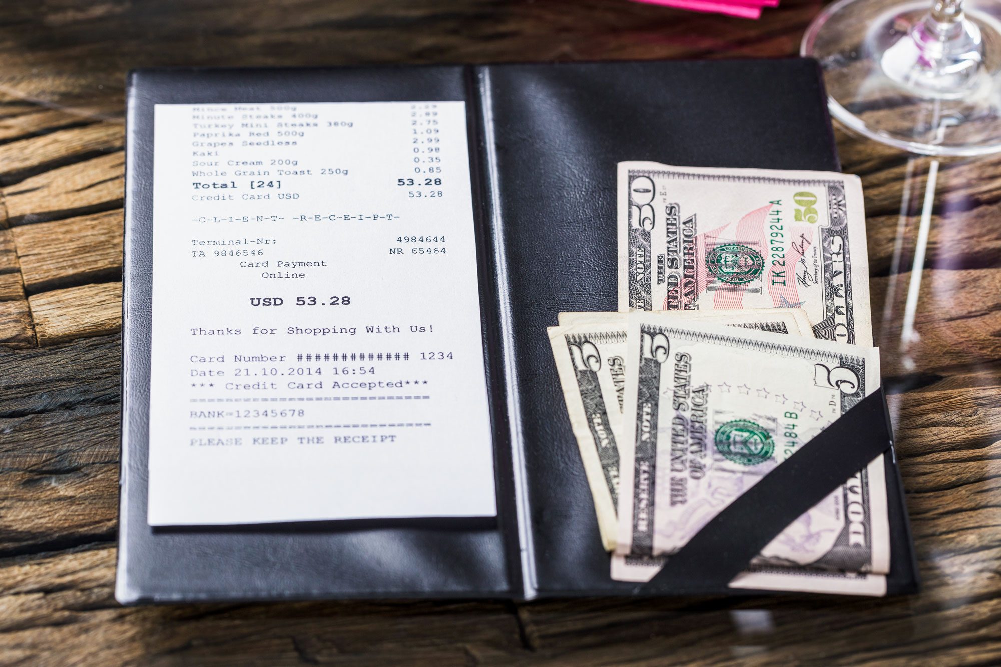 Elevated View Of Bill And Banknote On Wooden Desk