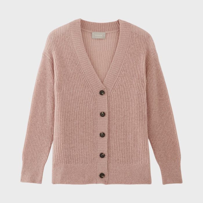 Pink cardigan displayed flat with button closure, long sleeves, and ribbed texture on a white background.