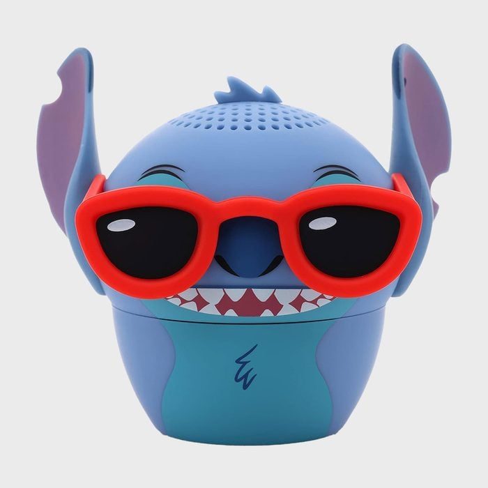 A blue cartoon character wears red sunglasses, smiling widely; against a plain white background.
