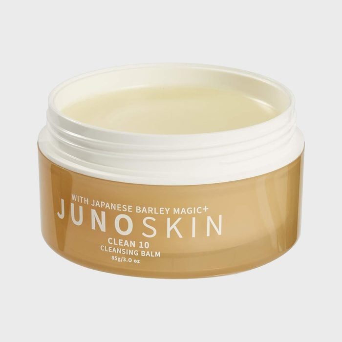 Open tub of cleansing balm labeled 