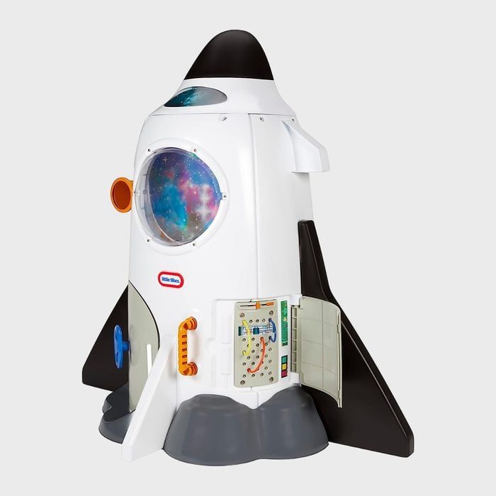 Toy spaceship stands upright with colorful controls and detailed design; placed against a plain background.