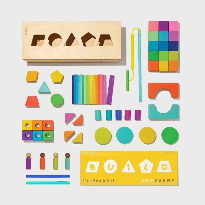 Colorful wooden blocks are arranged neatly, featuring various shapes and sizes, alongside a yellow box labeled 