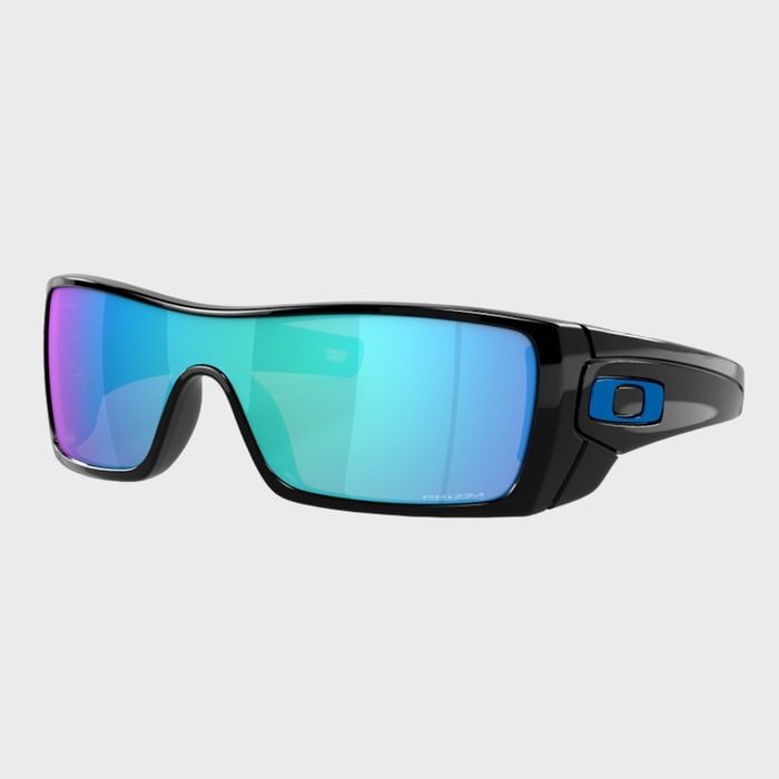 Sunglasses are resting, featuring sleek black frames and vibrant blue-tinted lenses, set against a plain gray background.