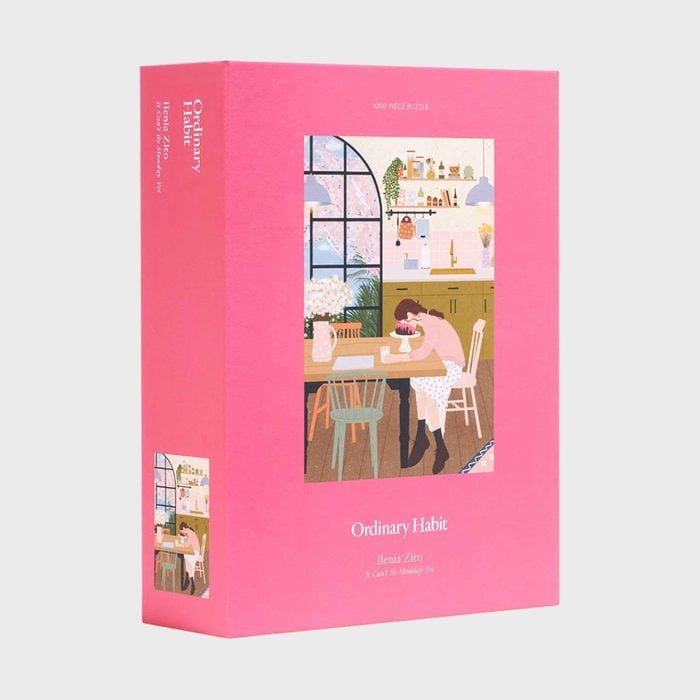 Puzzle box displays a colorful kitchen scene; a person sits at a table in a cozy kitchen. Text: 
