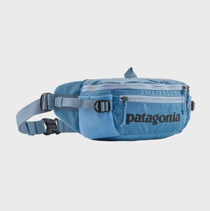 Blue waist bag with two zippered pockets, adjustable buckles, and 