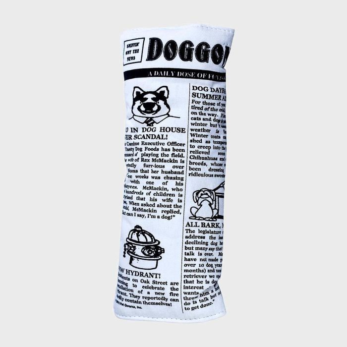 Dog toy shaped like a rolled newspaper, featuring playful, dog-themed headlines and illustrations. The background is plain gray.