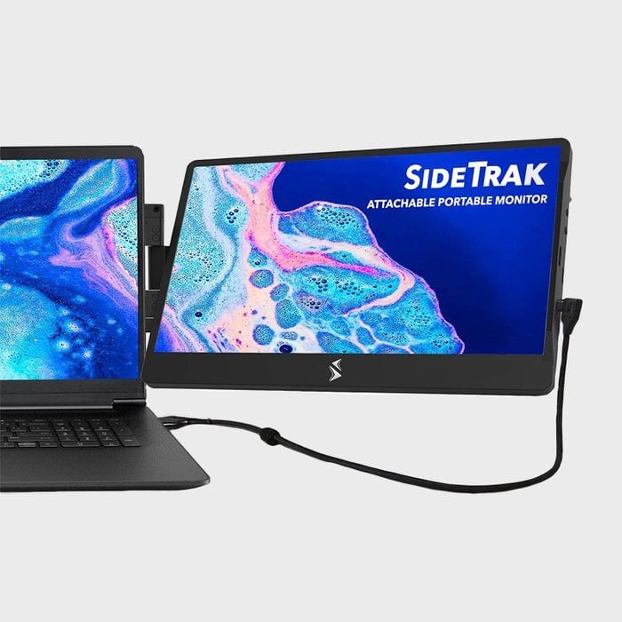 Monitor displays colorful pattern, attached to laptop with cable; text reads 