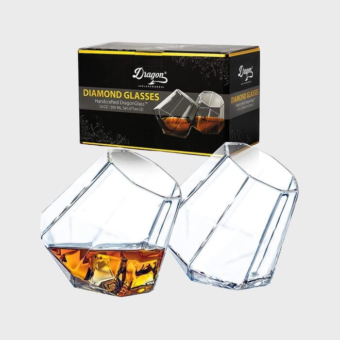 Diamond-shaped glasses filled with whiskey tilt slightly; packaging displays similar glasses, labeled 