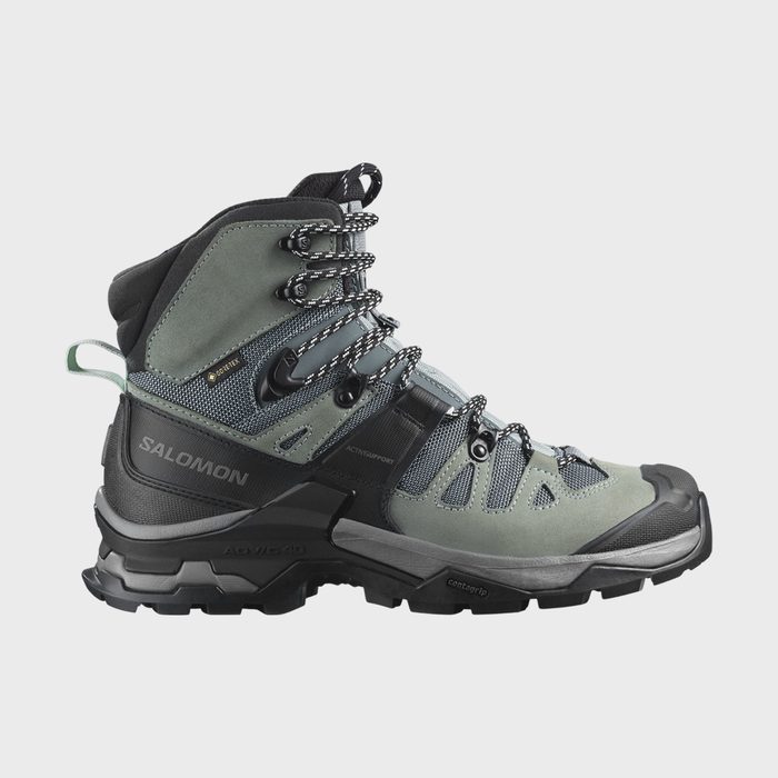 Boot displayed side-on, laced tightly, featuring robust design with green-gray and black colors. Text reads 