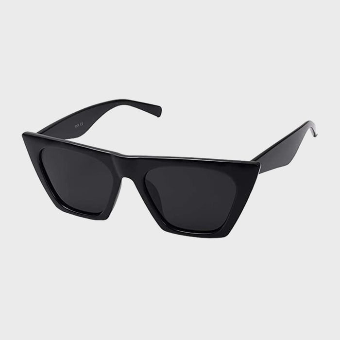 Black cat-eye sunglasses resting against a plain gray background; angular lenses emphasize a bold, stylish design.