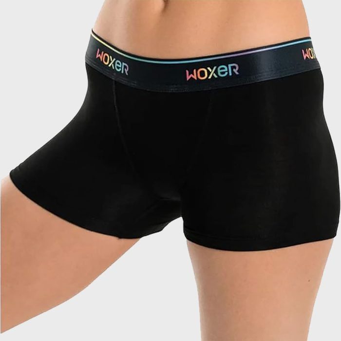Black boxer briefs are worn on a person, featuring a colorful waistband with the text 