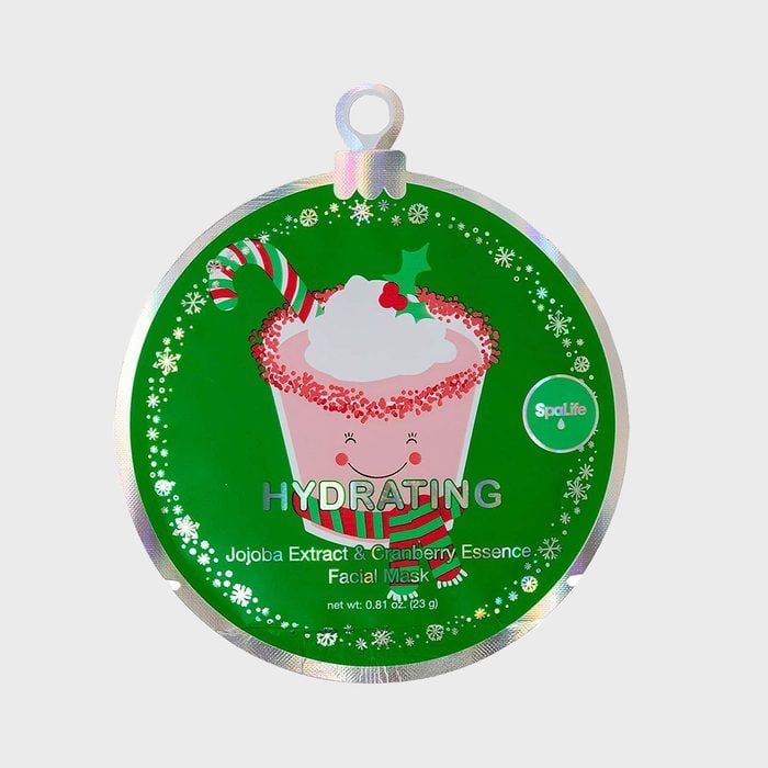 Facial mask package displaying smiling cup with candy cane, surrounded by festive decorations and text, 