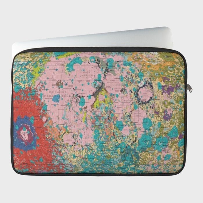 Laptop sleeve displays colorful lunar map design; lies against plain white background.