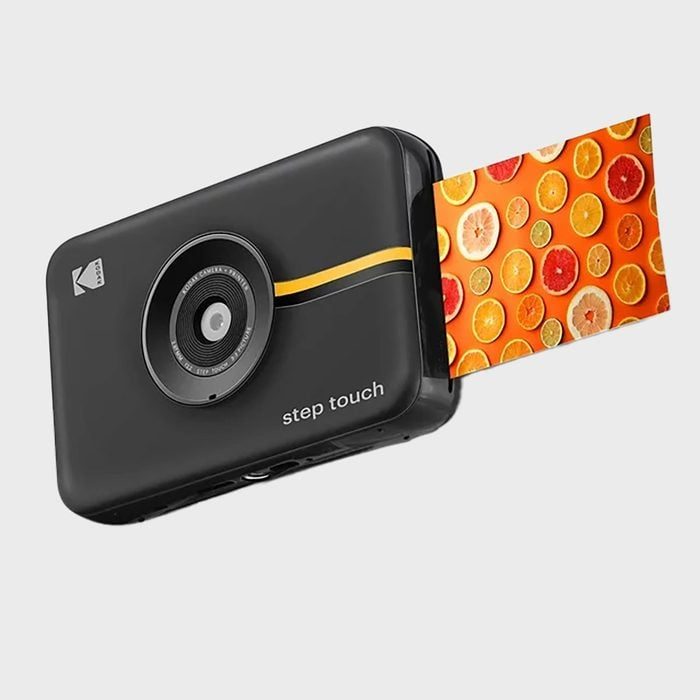 Camera prints colorful fruit photo on white background.