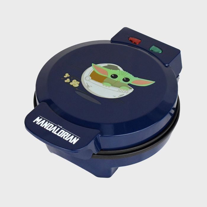 Waffle maker shows cartoon alien in a cradle, featuring 