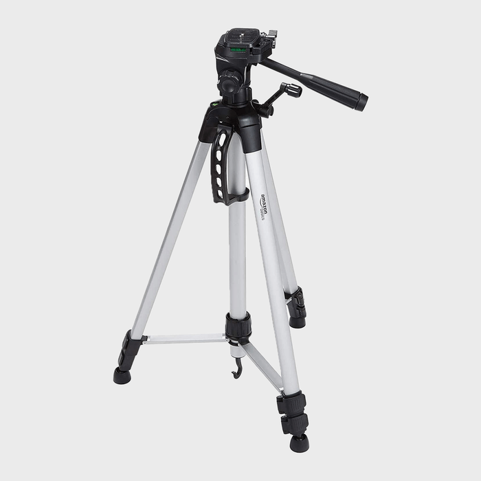 A tripod stands extended with a tilt handle; silver legs and black joints, set against a plain white background.