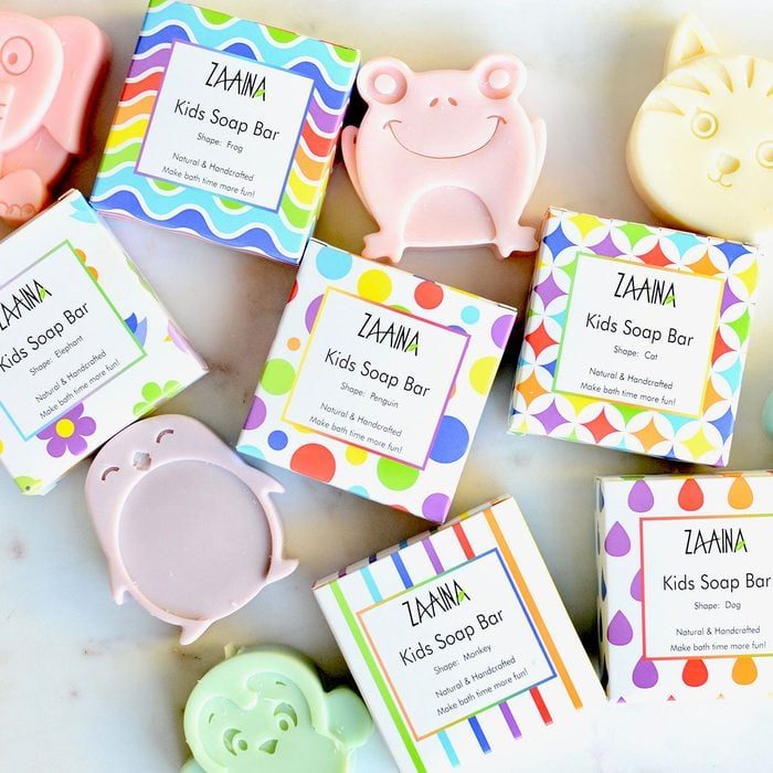 Colorful boxed kids soaps with playful shapes arranged on a surface; each box labeled 