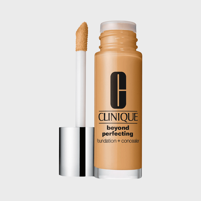 Bottle holds liquid foundation with applicator alongside in a neutral setting. Text reads: 