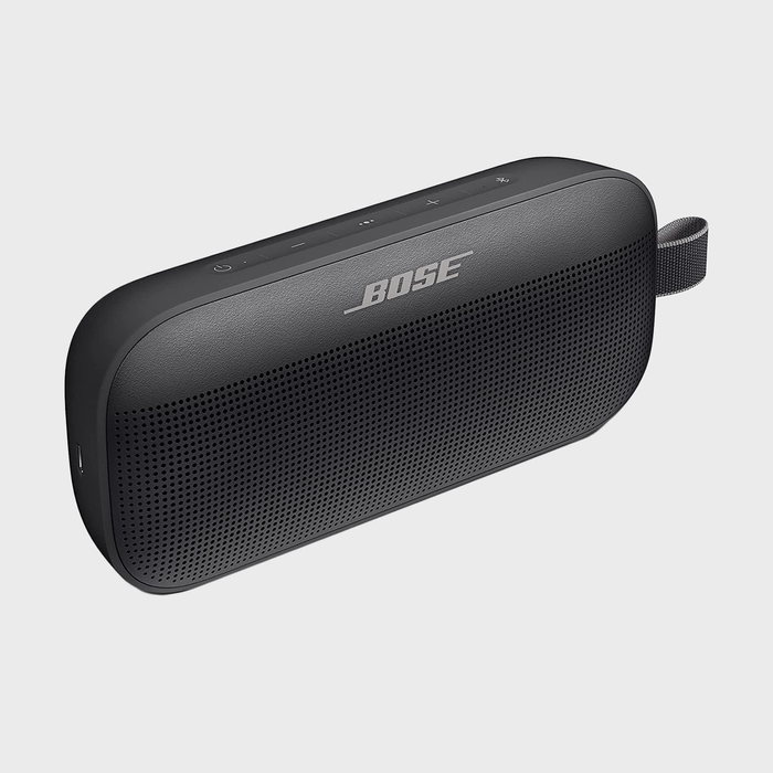 A black Bose speaker with control buttons rests against a plain, light background.