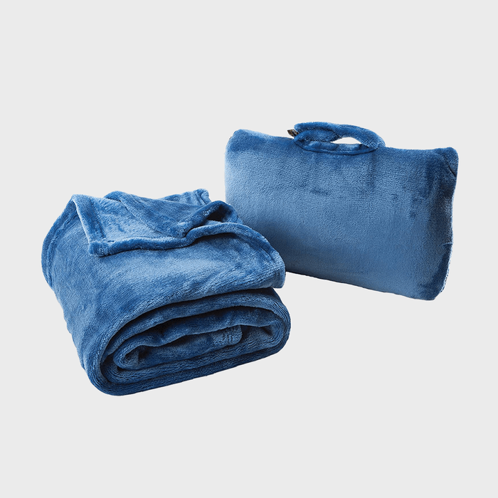 Two blue plush travel blankets, one folded and one packed with a handle, against a plain white background.